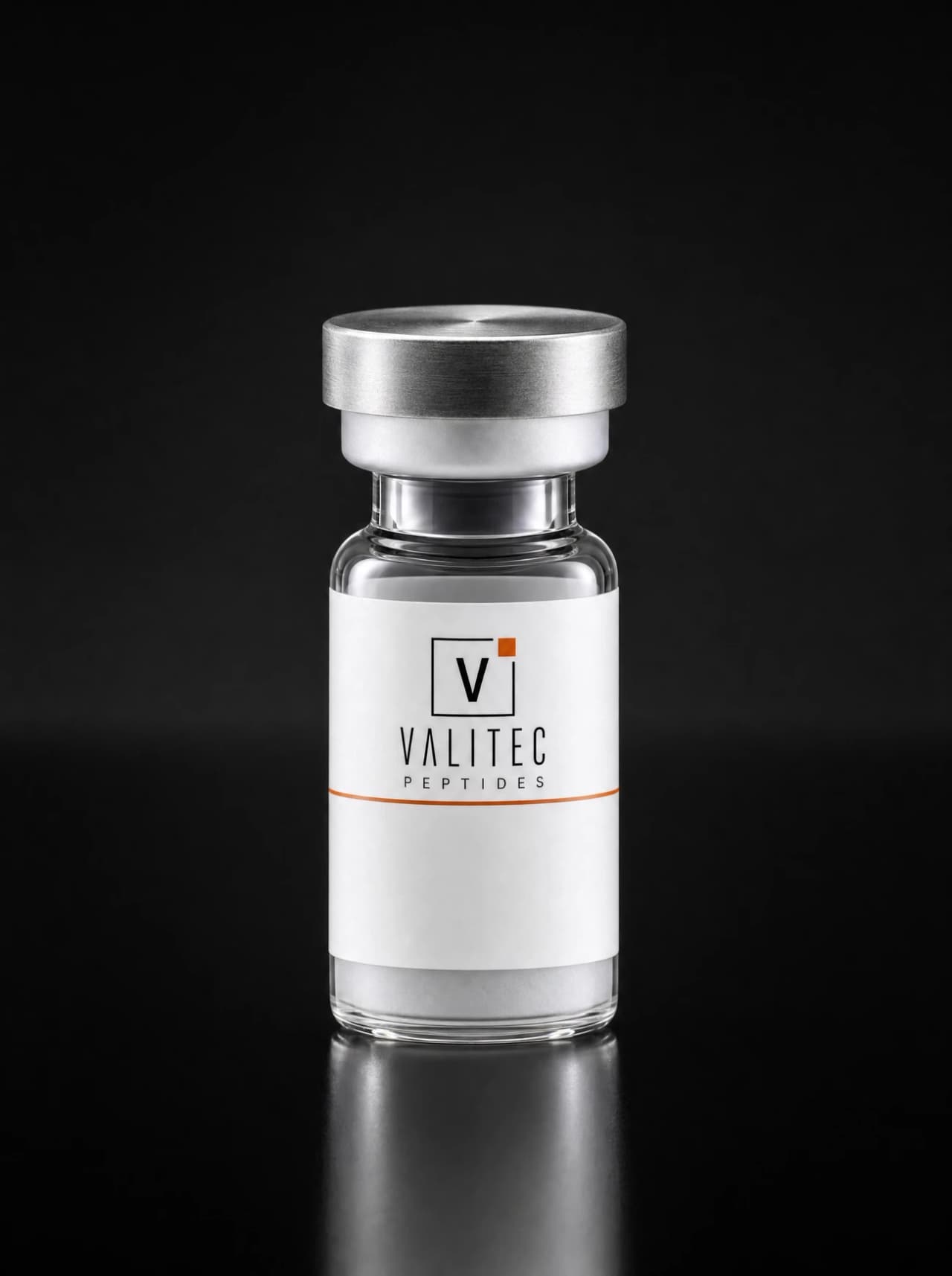 A Valitec Peptides research vial with a brushed crimp cap on a graphite surface under hard directional light.